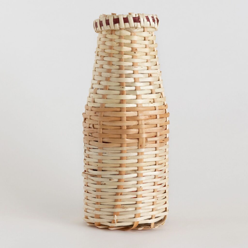 Willow-vine-wrapped glass milk bottle. Vine weaving