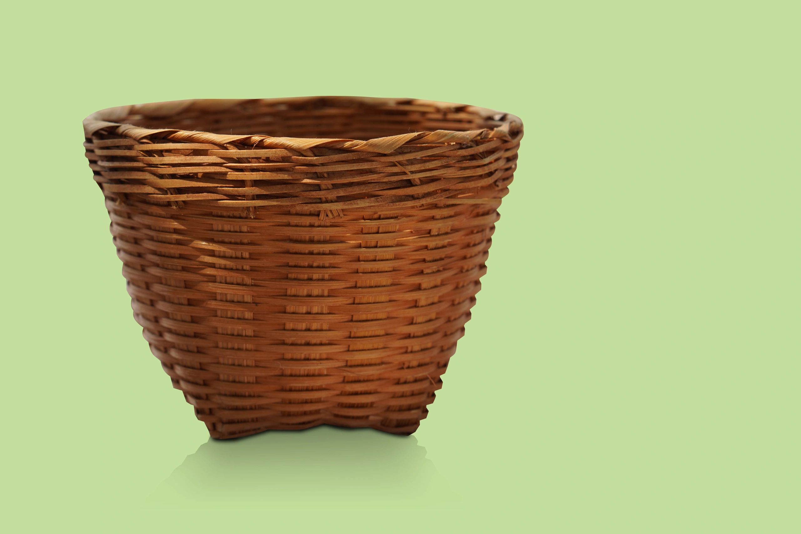 Handwoven basket displayed against a green background